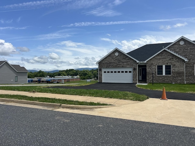 81 Meriwether Cir, Stuarts Draft, VA 24477 - view of front of property featuring an attached garage, asphalt driveway, brick siding, and a mountain view