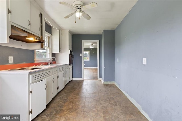 4970 Ridge Rd, Spotsylvania, VA 22551 - kitchen with under cabinet range hood, a ceiling fan, white electric cooktop, light countertops, and white cabinets
