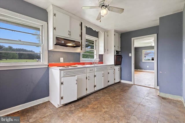4970 Ridge Rd, Spotsylvania, VA 22551 - kitchen featuring black oven, under cabinet range hood, white cabinets, and a ceiling fan