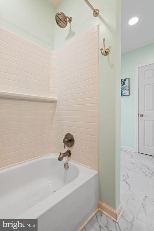 11104 Piney Forest Rd, Bumpass, VA 23024 - full bath with marble look tiles, baseboards, shower / tub combination, and recessed lighting
