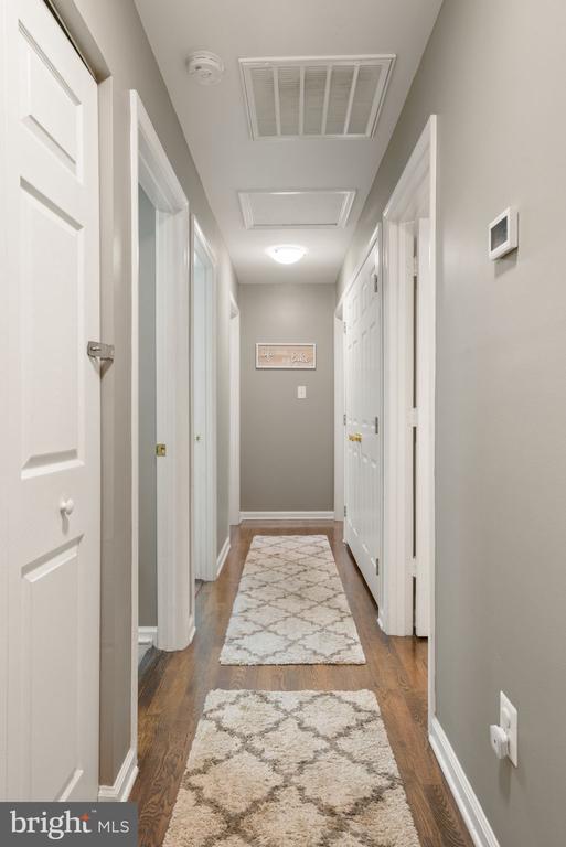 11104 Piney Forest Rd, Bumpass, VA 23024 - corridor featuring dark wood-style flooring, baseboards, and attic access