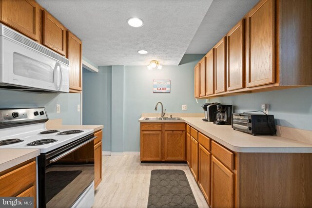 11104 Piney Forest Rd, Bumpass, VA 23024 - kitchen featuring range with electric cooktop, white microwave, a sink, a textured ceiling, and light countertops