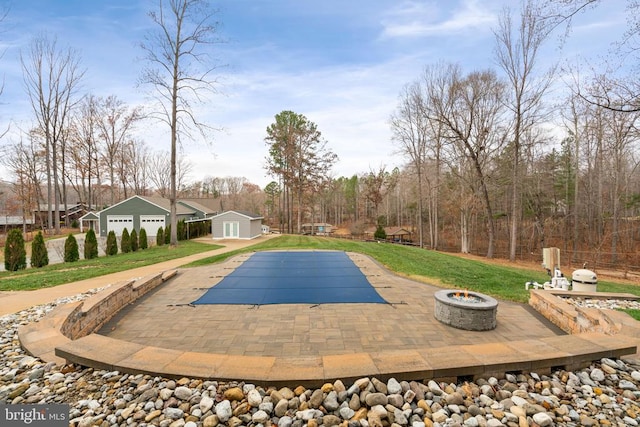 11104 Piney Forest Rd, Bumpass, VA 23024 - view of pool featuring a patio, a covered pool, a fire pit, an outdoor structure, and a lawn