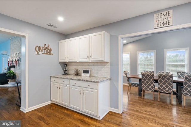 11104 Piney Forest Rd, Bumpass, VA 23024 - kitchen with backsplash, dark wood-style flooring, white cabinetry, baseboards, and light stone counters