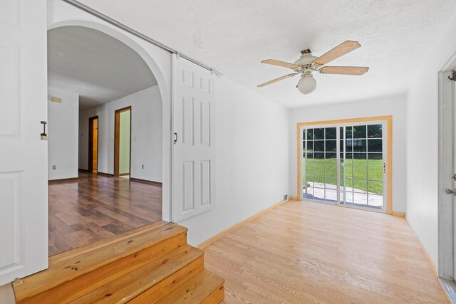 57 Greenbriar Ln, Stuarts Draft, VA 24477 - spare room featuring arched walkways, wood finished floors, a ceiling fan, and a textured ceiling