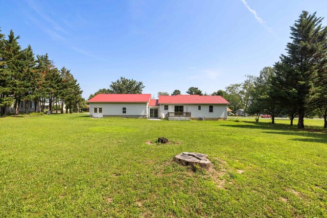 57 Greenbriar Ln, Stuarts Draft, VA 24477 - rear view of property featuring a lawn and a metal roof