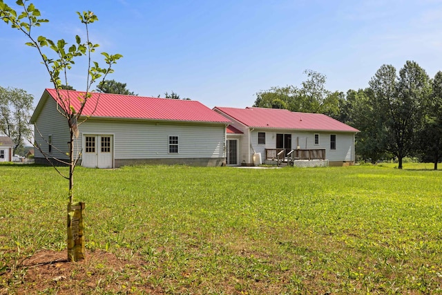 57 Greenbriar Ln, Stuarts Draft, VA 24477 - back of house featuring a wooden deck, a yard, and a metal roof