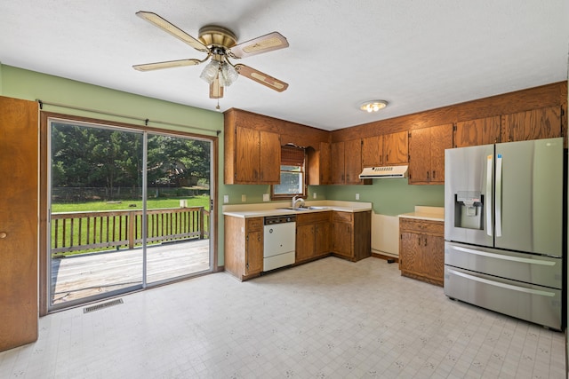 57 Greenbriar Ln, Stuarts Draft, VA 24477 - kitchen with stainless steel fridge, dishwasher, under cabinet range hood, a ceiling fan, and brown cabinets