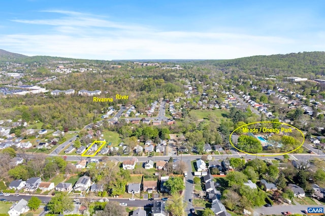 aerial overview of property's location with nearby suburban area and a heavily wooded area