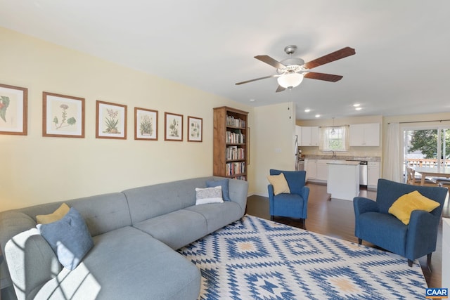living room with wood finished floors, a ceiling fan, and recessed lighting