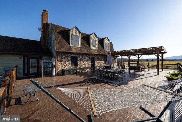 view of patio / terrace featuring a pergola, fence, a wooden deck, and outdoor dining area