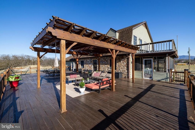 wooden terrace featuring a pergola and an outdoor living space