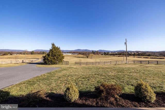 view of yard featuring a rural view and a mountain view