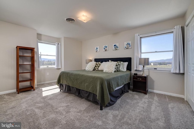 carpeted bedroom featuring baseboards