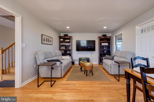 living room featuring stairs, light wood finished floors, recessed lighting, and baseboards