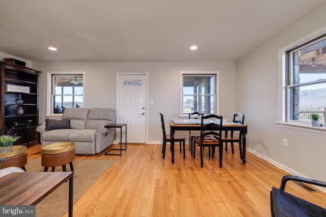 living area with plenty of natural light, light wood-type flooring, baseboards, and recessed lighting