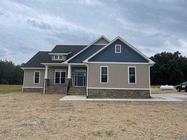 craftsman inspired home featuring covered porch
