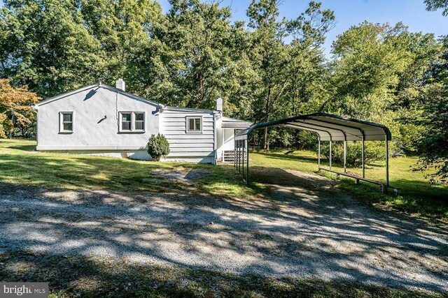 1055 Hacktown Rd, Keswick, VA 22947 - view of home's exterior with driveway, a carport, and a yard
