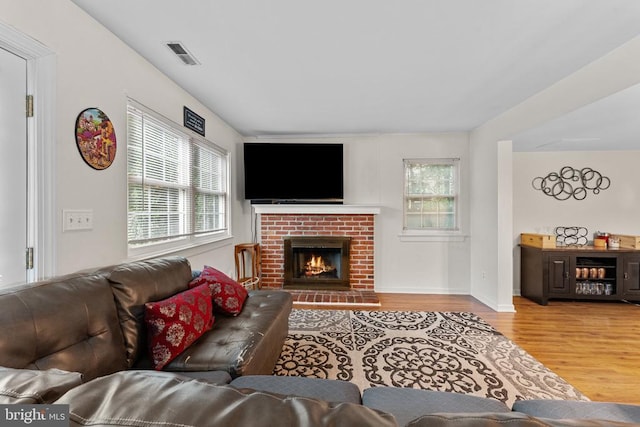 133 Woodlake Dr, Charlottesville, VA 22901 - living area with wood finished floors, healthy amount of natural light, a fireplace, and baseboards