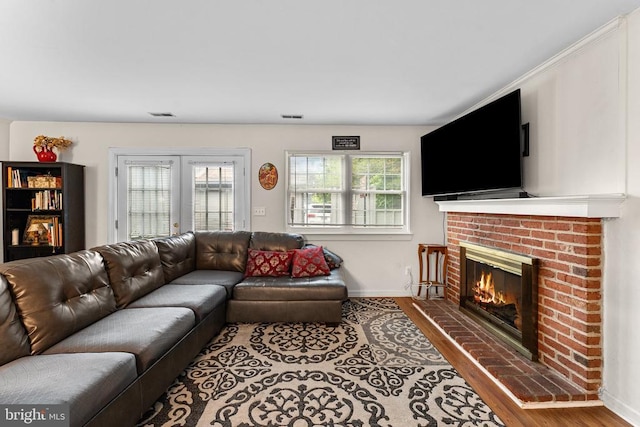 133 Woodlake Dr, Charlottesville, VA 22901 - living area with wood finished floors, a brick fireplace, and baseboards