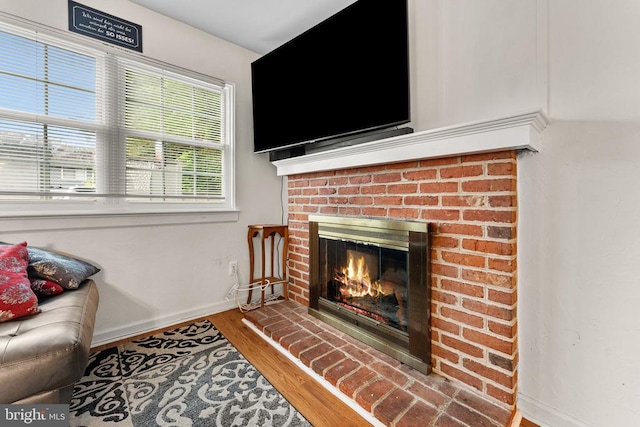 133 Woodlake Dr, Charlottesville, VA 22901 - living room featuring a brick fireplace, baseboards, and wood finished floors
