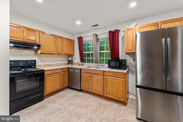 133 Woodlake Dr, Charlottesville, VA 22901 - kitchen with black appliances, under cabinet range hood, a sink, light countertops, and recessed lighting