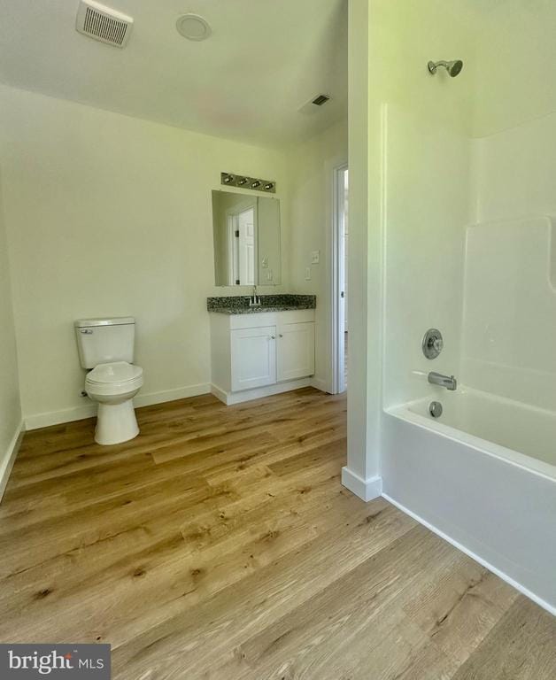 6273 Tatum Rd, Culpeper, VA 22701 - bathroom with wood finished floors, bathtub / shower combination, toilet, vanity, and baseboards