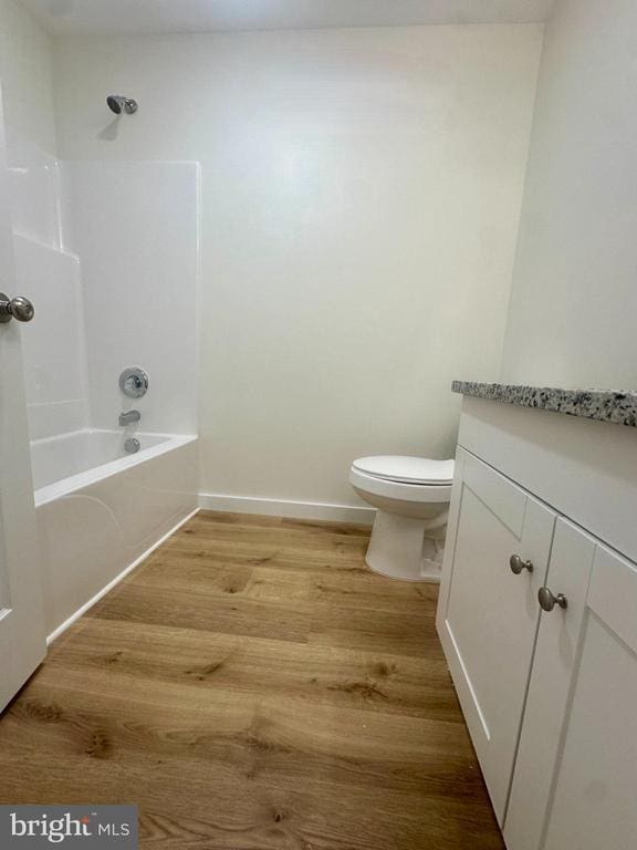 6273 Tatum Rd, Culpeper, VA 22701 - bathroom featuring wood finished floors, toilet, shower / bath combination, baseboards, and vanity