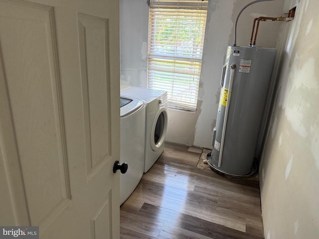 231 Derby Ln, Louisa, VA 23093 - washroom with water heater, washing machine and clothes dryer, and wood finished floors