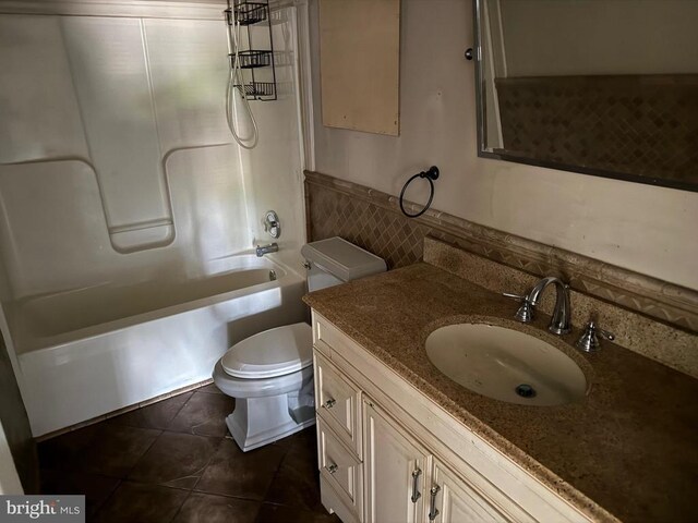 231 Derby Ln, Louisa, VA 23093 - bathroom with vanity, tile patterned floors, tile walls, tub / shower combination, and a wainscoted wall