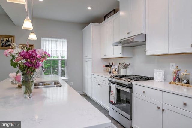 11316 Oakville Ln, Spotsylvania, VA 22551 - kitchen with under cabinet range hood, stainless steel gas range oven, white cabinets, and recessed lighting