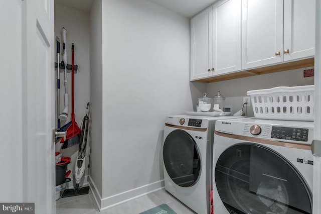 11316 Oakville Ln, Spotsylvania, VA 22551 - washroom with washing machine and clothes dryer, cabinet space, light tile patterned floors, and baseboards