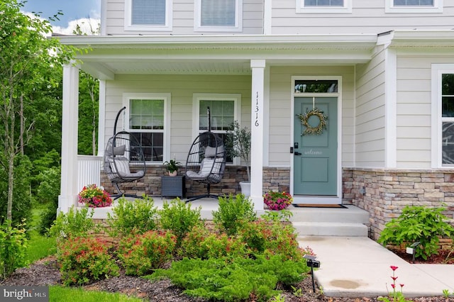 11316 Oakville Ln, Spotsylvania, VA 22551 - doorway to property with covered porch and stone siding