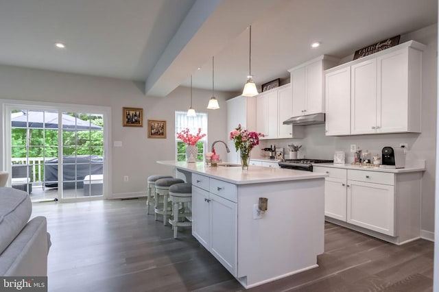 11316 Oakville Ln, Spotsylvania, VA 22551 - kitchen featuring under cabinet range hood, gas range, baseboards, a sink, and plenty of natural light