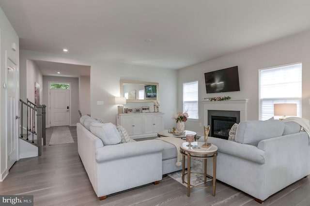 11316 Oakville Ln, Spotsylvania, VA 22551 - living room featuring a glass covered fireplace, stairs, light wood-type flooring, baseboards, and recessed lighting