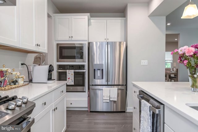 11316 Oakville Ln, Spotsylvania, VA 22551 - kitchen featuring appliances with stainless steel finishes, white cabinetry, dark wood finished floors, recessed lighting, and light stone counters