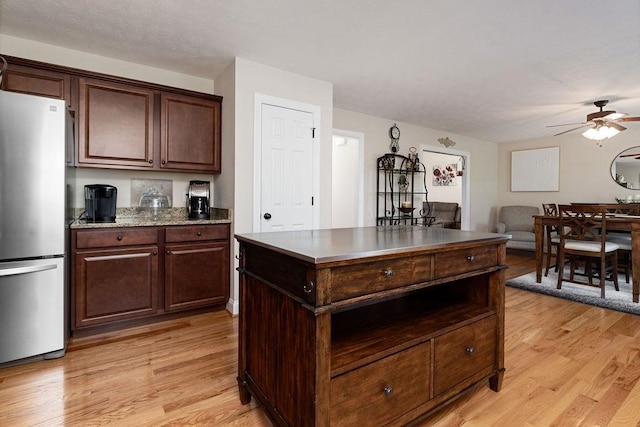 15 Devonshire Ct, Fishersville, VA 22939 - kitchen with freestanding refrigerator, light wood-style floors, a ceiling fan, and a center island