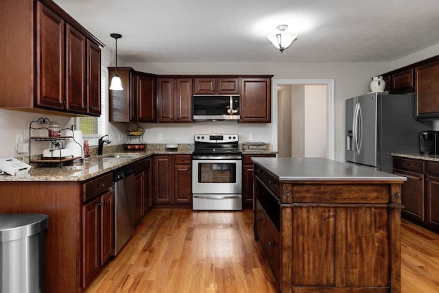 15 Devonshire Ct, Fishersville, VA 22939 - kitchen featuring appliances with stainless steel finishes, light wood-type flooring, a center island, a sink, and pendant lighting
