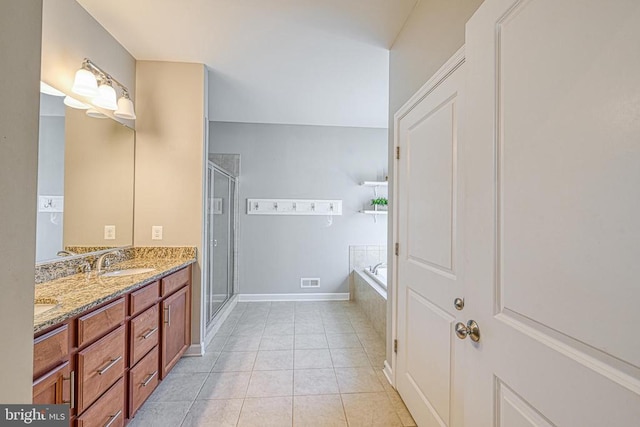 299 Sunset Loop, Mineral, VA 23117 - full bath featuring double vanity, a shower stall, a bath, tile patterned flooring, and baseboards