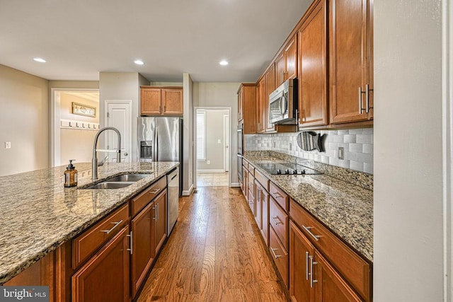 299 Sunset Loop, Mineral, VA 23117 - kitchen featuring a sink, stainless steel appliances, dark wood finished floors, stone countertops, and brown cabinets