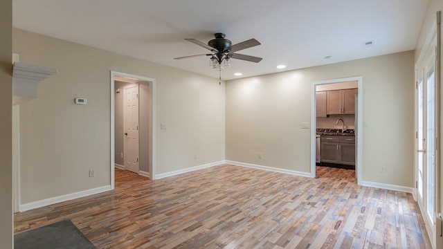 822 Meadowlark Dr, Harrisonburg, VA 22850 - unfurnished room with light wood-style flooring, ceiling fan, recessed lighting, baseboards, and a sink