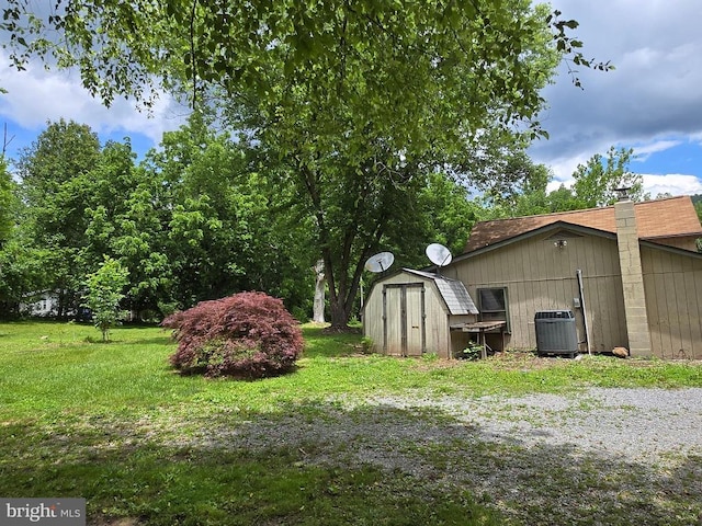  - view of grassy yard with a storage shed