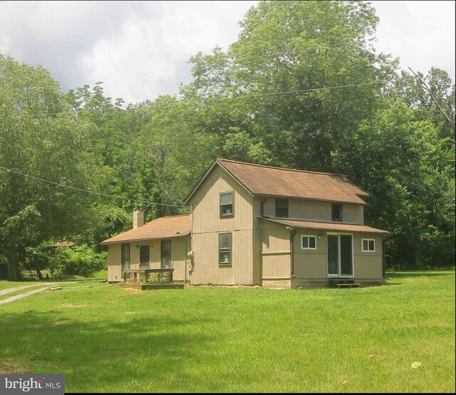  - back of property with a yard and a chimney