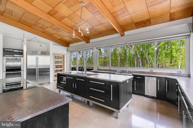  - kitchen with dark cabinetry, built in appliances, wood ceiling, a center island with sink, and hanging light fixtures