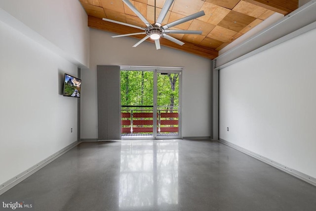 empty room with a ceiling fan, concrete floors, wood ceiling, and vaulted ceiling