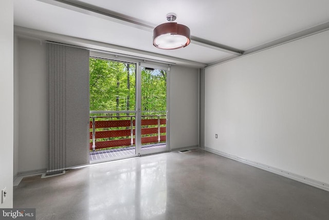 empty room with concrete flooring