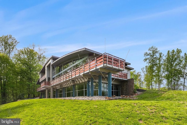  - rear view of property with a lawn and a deck