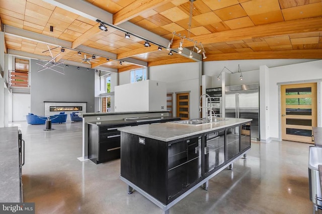  - kitchen with dark cabinetry, a wood ceiling with exposed beams, concrete flooring, an island with sink, and healthy amount of natural light