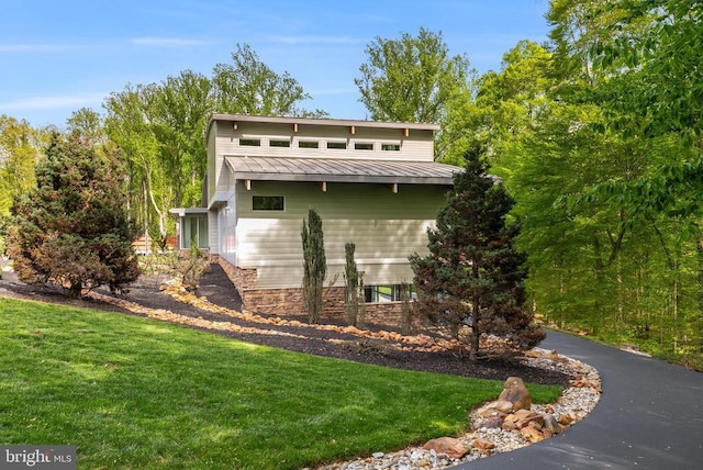  - view of front of home with a front lawn, a metal roof, and a standing seam roof