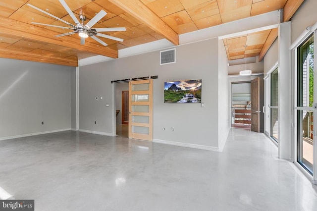 empty room featuring visible vents, a barn door, concrete flooring, baseboards, and wooden ceiling